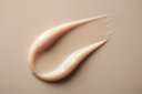 A rich moisturizing cream texture macro shot, thick hydrating swipe on a matte neutral background, soft warm lighting, subtle glow, premium skincare editorial style, soothing and nourishing mood, high detail, photorealistic 4K, minimal and clean composition