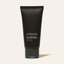 A black squeeze tube of CARDON SPF + Moisturizer with white text, standing upright against a light beige background with a soft shadow.