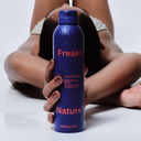 Person holding a blue bottle labeled 'Freaks Nature' against a neutral background