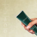Hand holding a Heath Shave Cream bar with green packaging on a beige background
